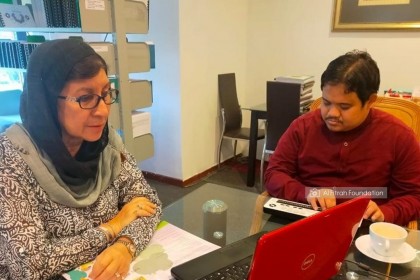 2.One of her poems was inspired by Majid. In this photo, Datin is reading a book and Majid is transcribing the text into braille